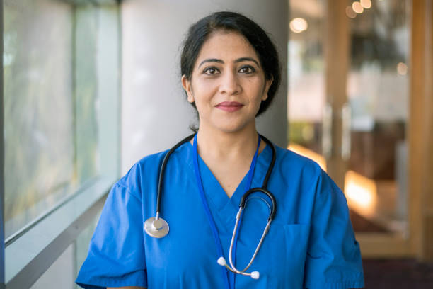 Portrait of a female physician in blue scrubs with a stethoscope