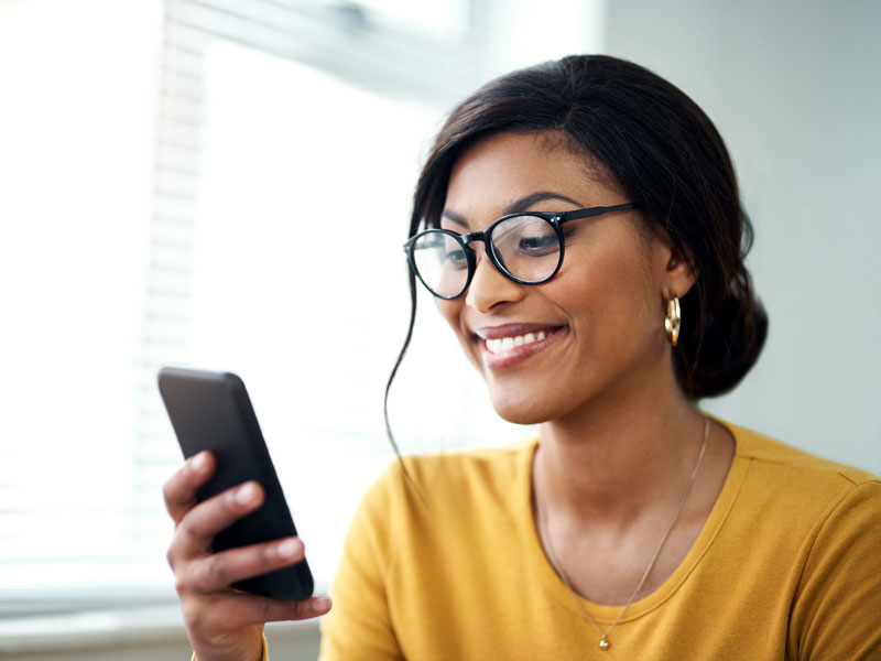 A woman messaging her care team from home